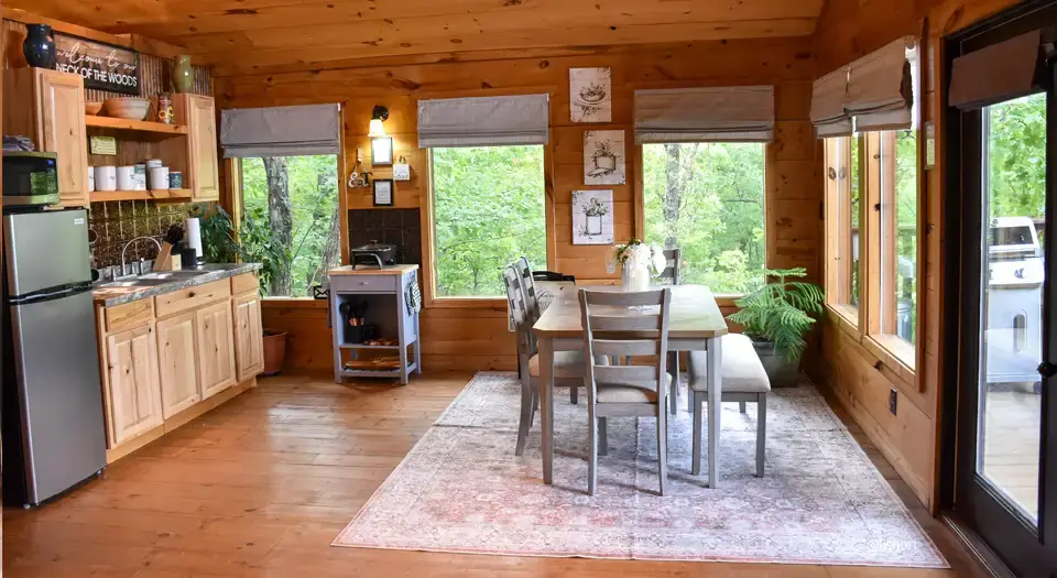 View of the kitchen and dining area inside the cabin at Eureka Springs Riverview Oasis