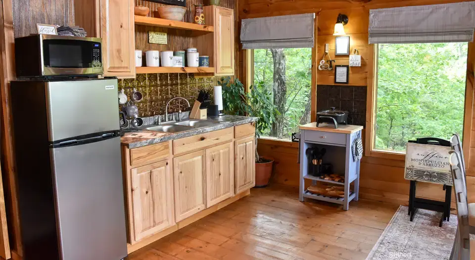 View of the kitchen area inside the cabin at Eureka Springs Riverview Oasis