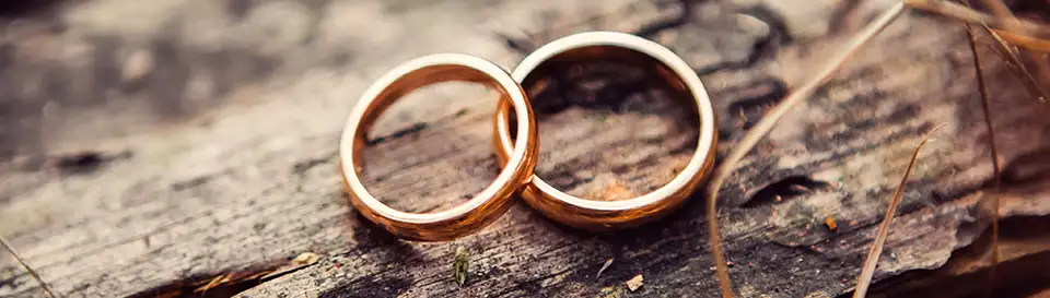 Two wedding rings on a log, are a perfect symbol for an Ozark Mountain wedding in Eureka Springs, Arkansas